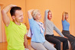 Senioren dehnen sich im Fitnesscenter