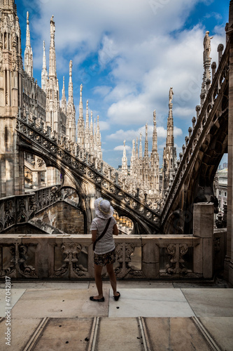 Photo: A tourist admires the spiers of Milan Cathedral Duomo. A tourist admires the spiers of Milan Cathedral Duomo.