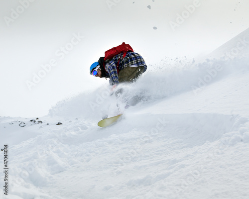 Photo: Snowboarder moving down Snowboarder moving down