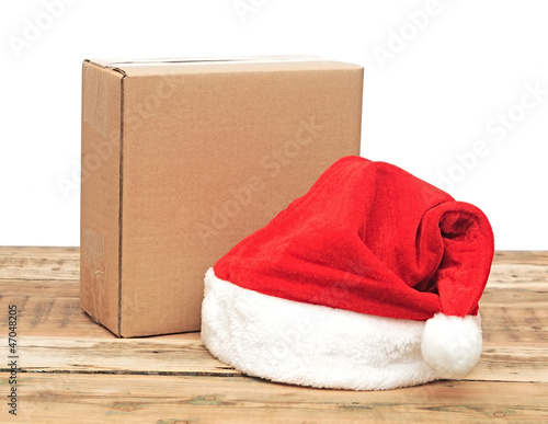 Photo: santa hat with brown cardboard box over white santa hat with brown cardboard box over white
