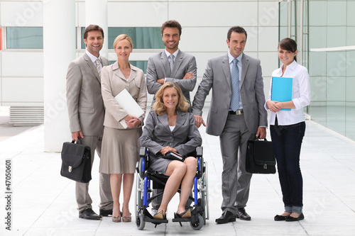 Photo: Business people stood outside building Business people stood outside building