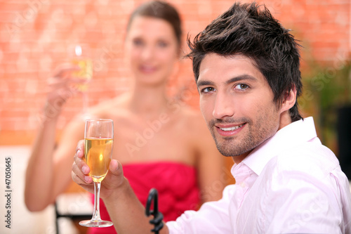 Photo: Couple on a date drinking champagne. Couple on a date drinking champagne.