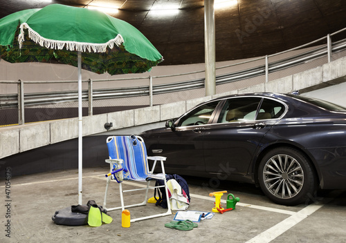 Photo: beach umbrella with deckchairs in a parking garage beach umbrella with deckchairs in a parking garage