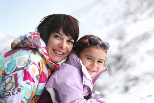 Photo: Mother and daughter on snowy mountain Mother and daughter on snowy mountain