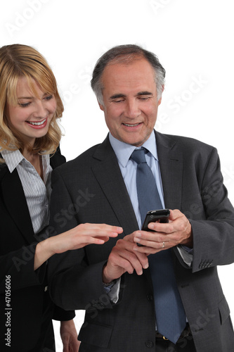 Photo: Boss showing a text message to his employee Boss showing a text message to his employee