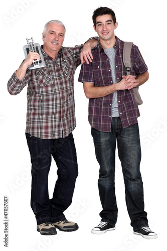 Photo: A grandfather teaching his grandson how to lay tiles. A grandfather teaching his grandson how to lay tiles.