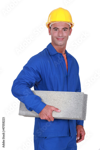 Photo: Smiling mason carrying a brick Smiling mason carrying a brick