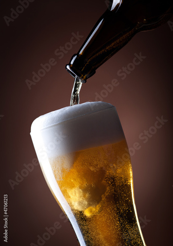 Photo: beer glass and bottle on a brown beer glass and bottle on a brown