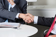 Photo: Midsection Of Businessmen Shaking Hands Midsection Of Businessmen Shaking Hands