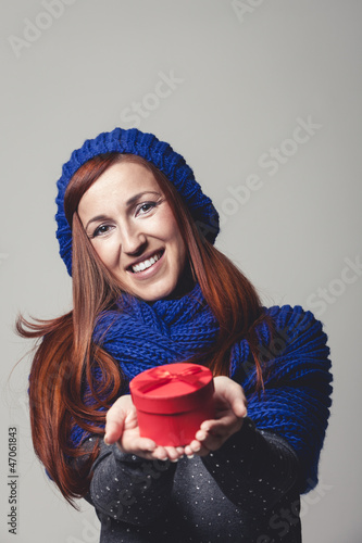 Photo: Beautiful woman holding a romantic gift Beautiful woman holding a romantic gift