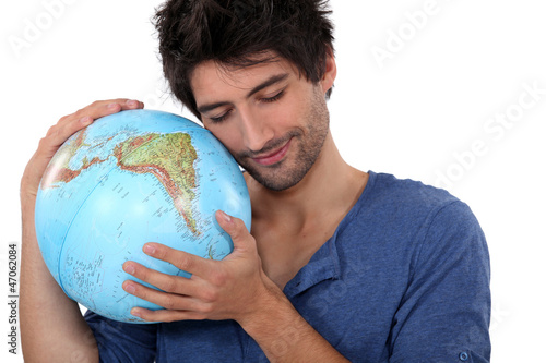 Photo: Man hugging a globe Man hugging a globe