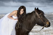 Bride with a horse in the snow
