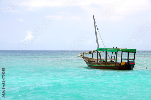Photo: Wooden boat floating on the turquoise sea Wooden boat floating on the turquoise sea