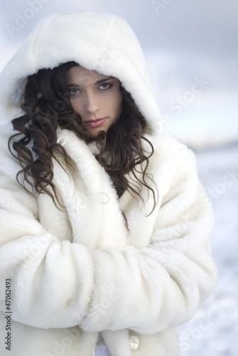 Photo: pretty young woman posing in wedding dress on winter snow pretty young woman posing in wedding dress on winter snow