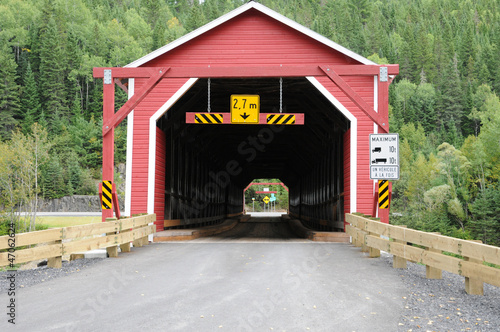 Photo: Quebec, a red covered bridge on Matapedia river in Gaspesie Quebec, a red covered bridge on Matapedia river in Gaspesie