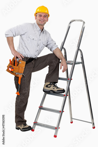 Photo: Handyman climbing ladder Handyman climbing ladder
