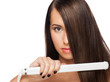 Foto: Woman with hair straightening irons Woman with hair straightening irons