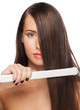 Foto: Woman with hair straightening irons Woman with hair straightening irons