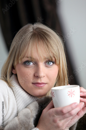 Photo: Woman drinking a hot drink Woman drinking a hot drink