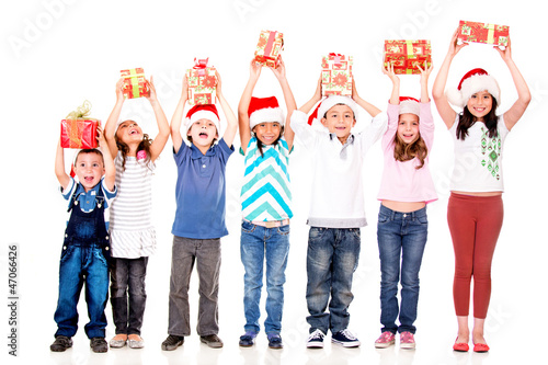 Photo: Excited children with Christmas gifts Excited children with Christmas gifts