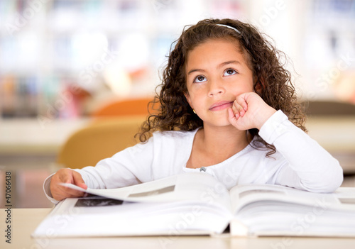 Photo: Thoughtful girl reading a book Thoughtful girl reading a book