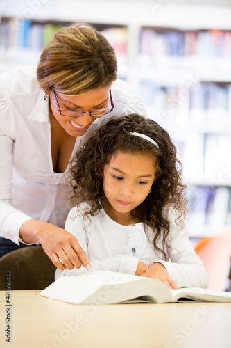 Photo: Schoolgirl reading with her teacher Schoolgirl reading with her teacher