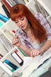 Redhead studying hard for her exams