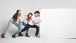 Young people pushing white board