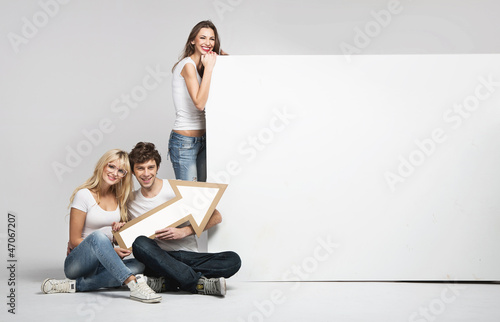 Photo: Handsome man with two girls and arrow Handsome man with two girls and arrow