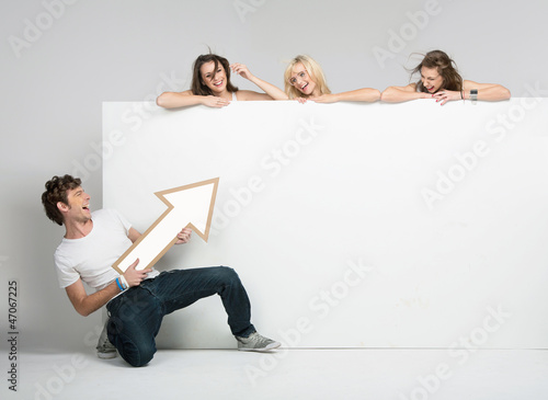 Photo: Young man pointing at advert Young man pointing at advert