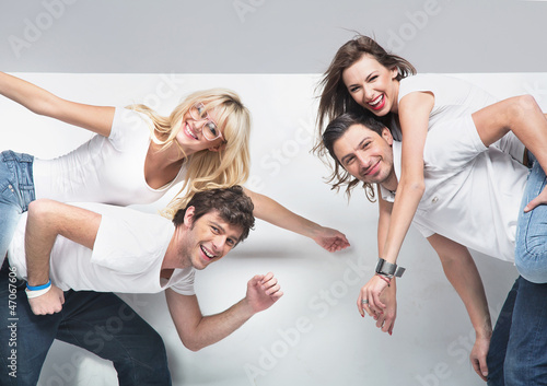 Photo: Smiling pleased couples with advert empty board Smiling pleased couples with advert empty board
