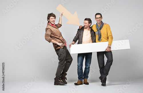 Photo: A band of male friends with signs A band of male friends with signs