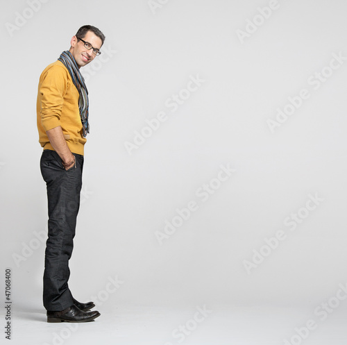 Photo: Handsome man casually leaning against the wall Handsome man casually leaning against the wall