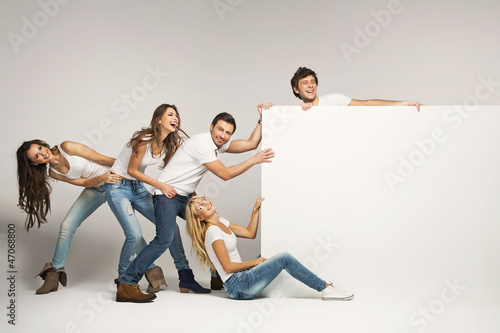 Photo: Business people pulling an empty board Business people pulling an empty board