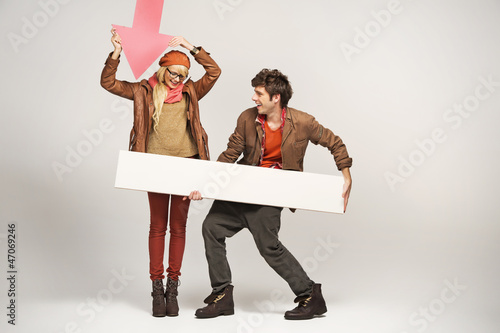 Photo: Smiling woman pointing on empty board Smiling woman pointing on empty board