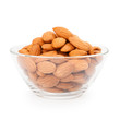 Glass bowl with almonds isolated on white background