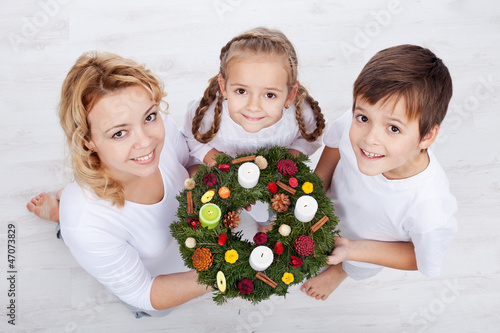 Photo: Woman with two kids holding advent wreath Woman with two kids holding advent wreath
