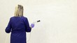 Woman working, washing and cleaning wall in office bathroom