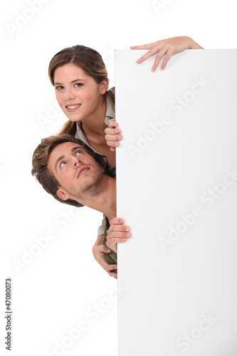 Photo: couple behind white panel couple behind white panel