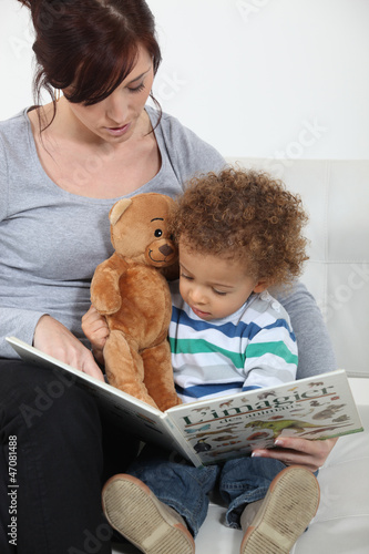 Photo: A mother reading to her son. A mother reading to her son.