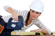 Female carpenter using a jigsaw.