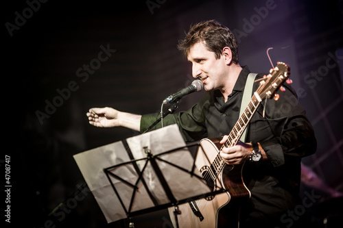 Photo: musician plays a guitar musician plays a guitar
