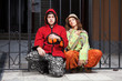 Photo: Young hippie couple sitting against an iron fence Young hippie couple sitting against an iron fence