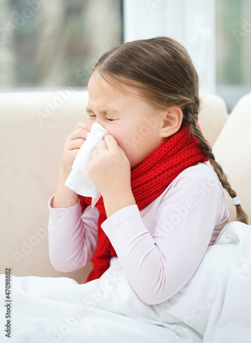 Photo: Little girl is blowing her nose Little girl is blowing her nose