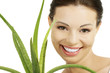 Young beautiful woman's face and aloe vera.