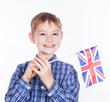 Foto: A little boy with english flag on the white background A little boy with english flag on the white background