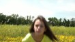 Girl Sits in Yellow Flower Field