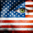 Flag painted on face with green eye to show USA support