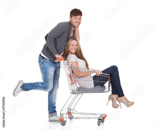 Photo: Man shopping with his wife in a trolley Man shopping with his wife in a trolley
