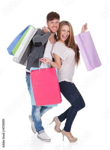 Photo: Guy and gal brings shopping bags Guy and gal brings shopping bags